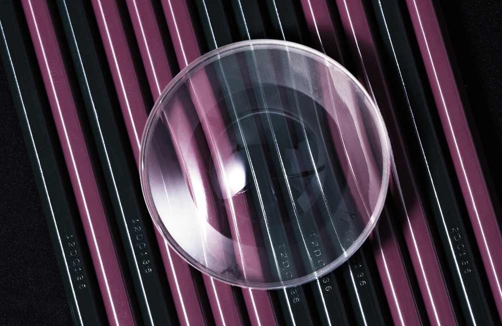 Aspherical Lens image on a row of pencil on a table